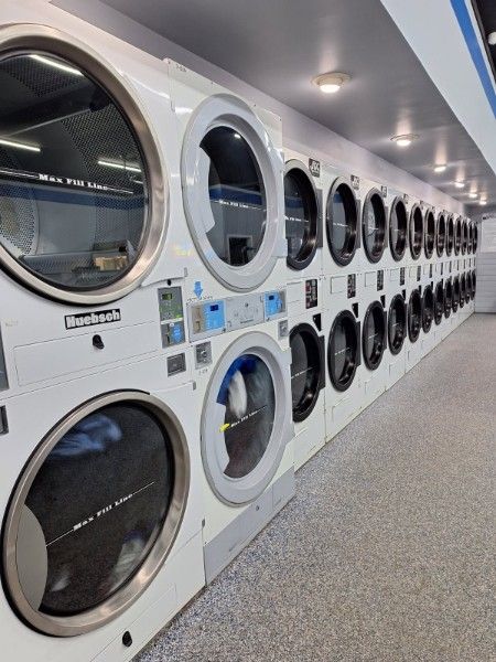 Wall of dryers at Lapeer Laundry